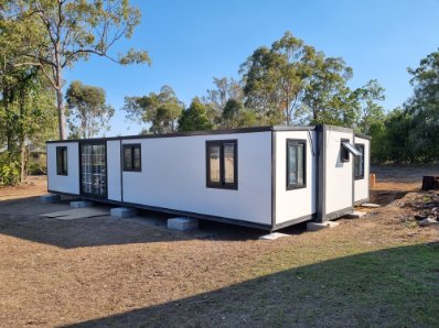 Completed tiny home installation with secure windows and finish