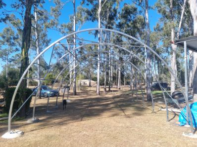 Carport dome shelter installation secured to containers in Queensland